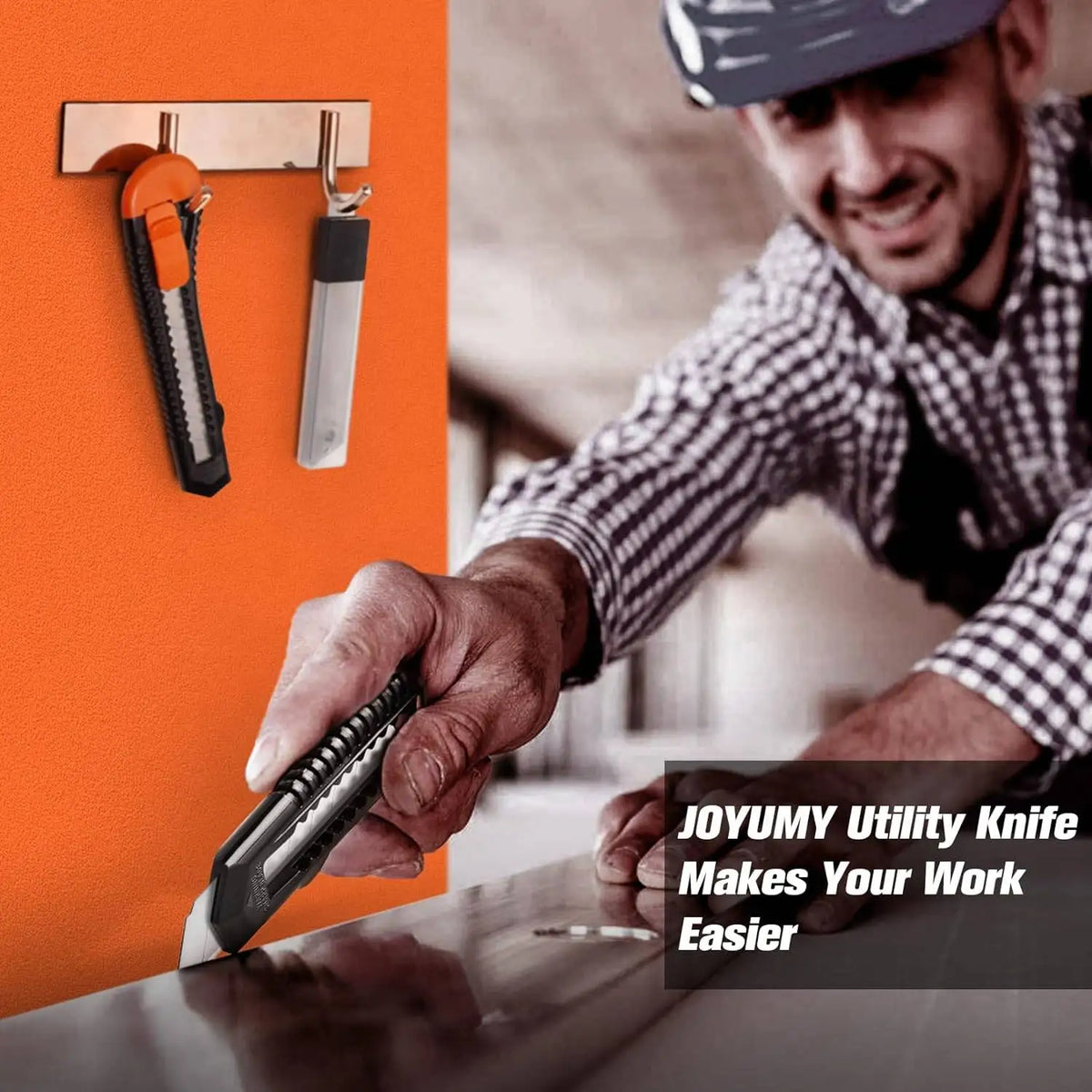A man uses a black utility knife from a holder to cut a piece of wood on a table.