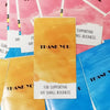 A stack of rectangular thank you gift stickers in shades of yellow, pink, and blue are displayed against a light background.
