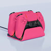 A pink Dual PS5 controller charging station with a dock and cable shown on a light gray surface.