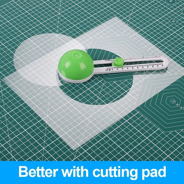 A green circular craft knife is shown resting on a white cutting pad with a grid pattern.