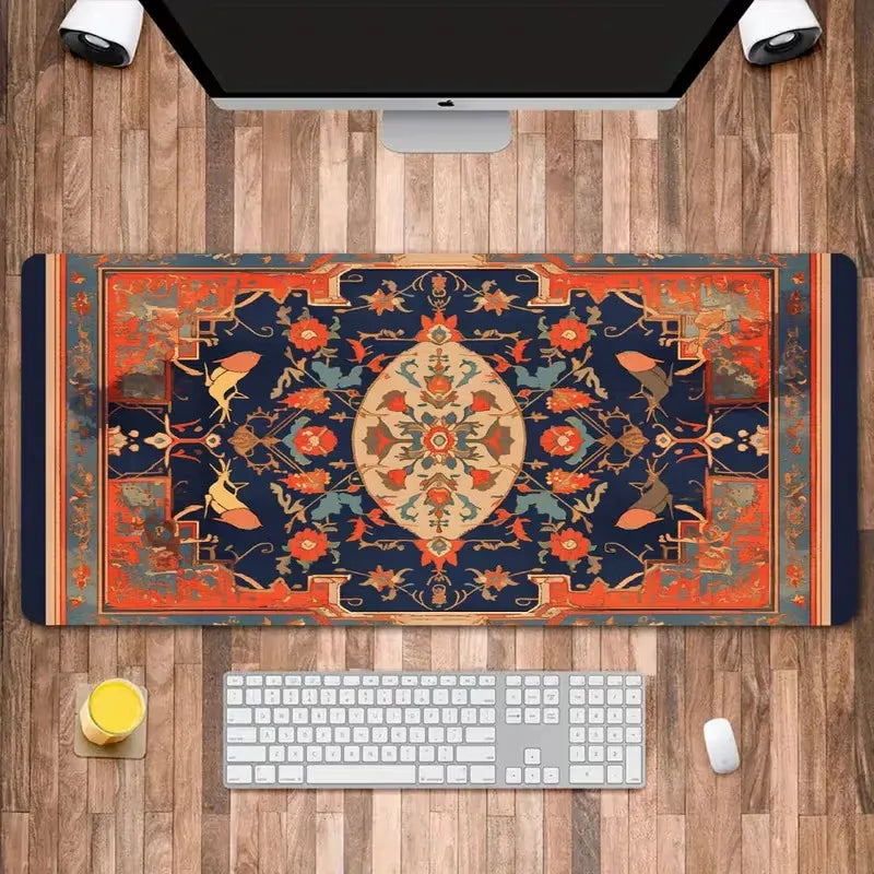 A vintage Persian rug design mouse pad featuring deep blue, orange, and gold patterns placed on a wooden desk with a computer