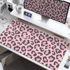 A large leopard print desk pad is displayed on a white desk next to various office supplies.