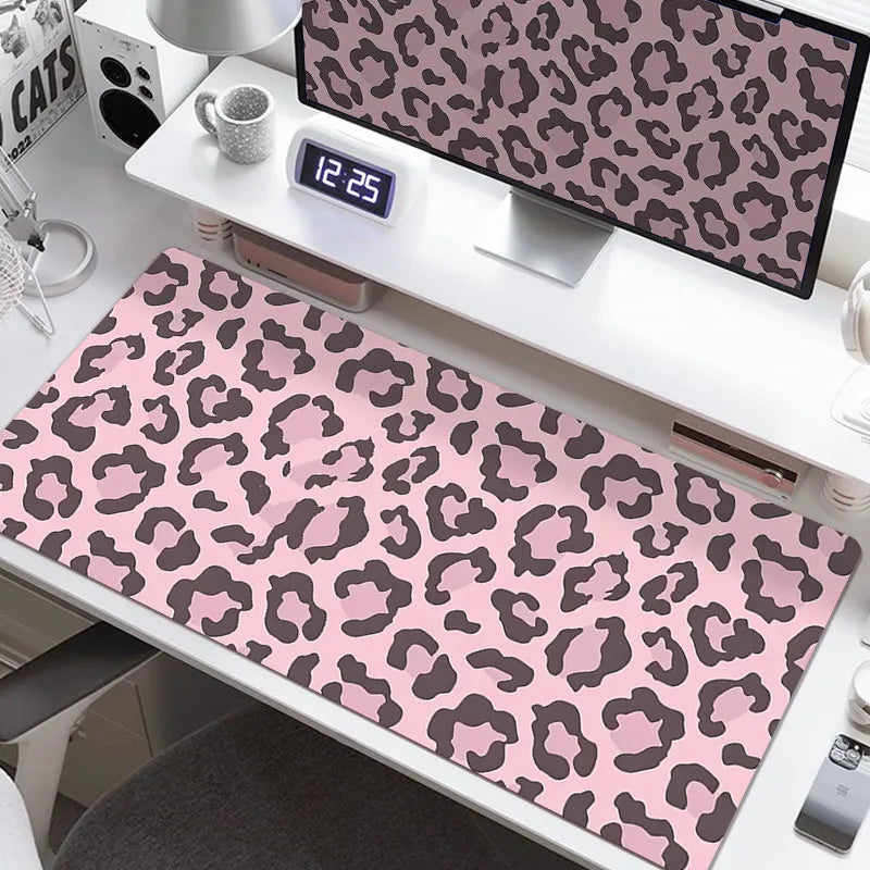 A large leopard print desk pad is displayed on a white desk next to various office supplies.