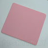 A pink professional gaming mouse pad desk mat lying flat on a light surface.