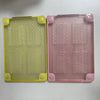 Two translucent hard shell laptop cases, one yellow and one pink, showing textured internal inserts.
