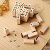A collection of vintage wooden stamp seals and blocks arranged on a brown paper background.