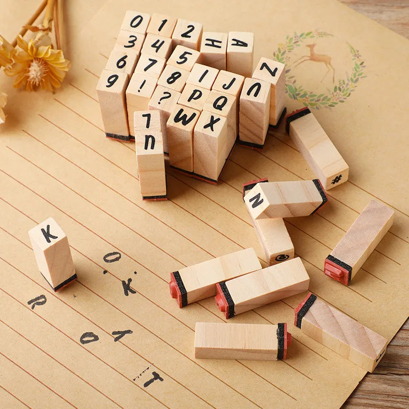 A collection of vintage wooden stamp seals and blocks arranged on a brown paper background.