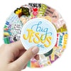 A hand holds a circular arrangement of inspirational Bible verse stickers featuring the text Big Jesus Gal