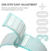 A close-up of a light blue hook and loop watch strap being adjusted on a wrist.