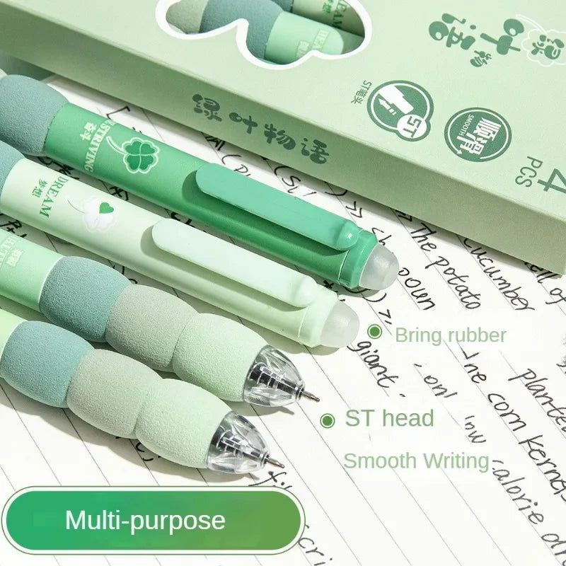 A set of light green and white erasable gel pens with soft grips lying on a sheet of lined paper.