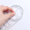 A hand is rotating a clear plastic geometric drawing ruler to demonstrate its 360 degree rotating angles.