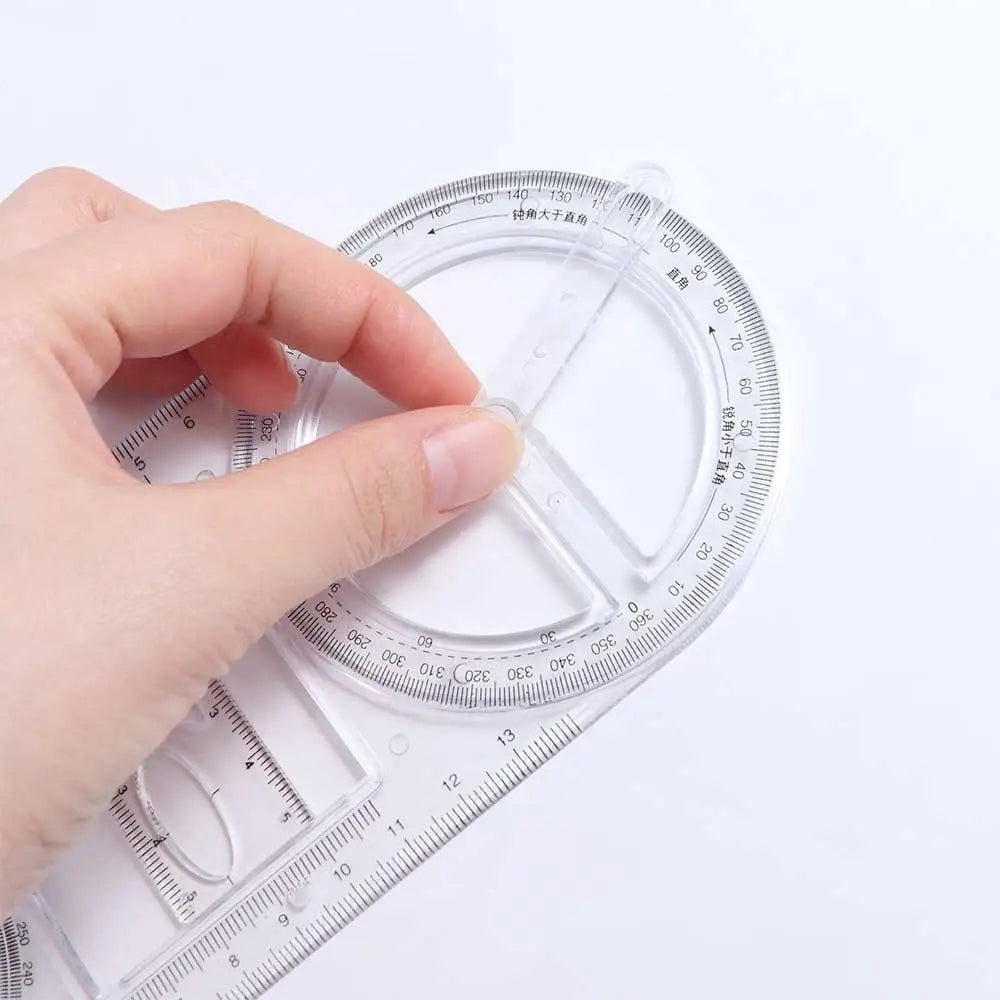 A hand is rotating a clear plastic geometric drawing ruler to demonstrate its 360 degree rotating angles.
