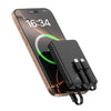 A portable power bank with a digital display is shown next to a smartphone.