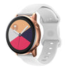A close-up of a rose gold smartwatch with a white silicone band displaying a watch face.