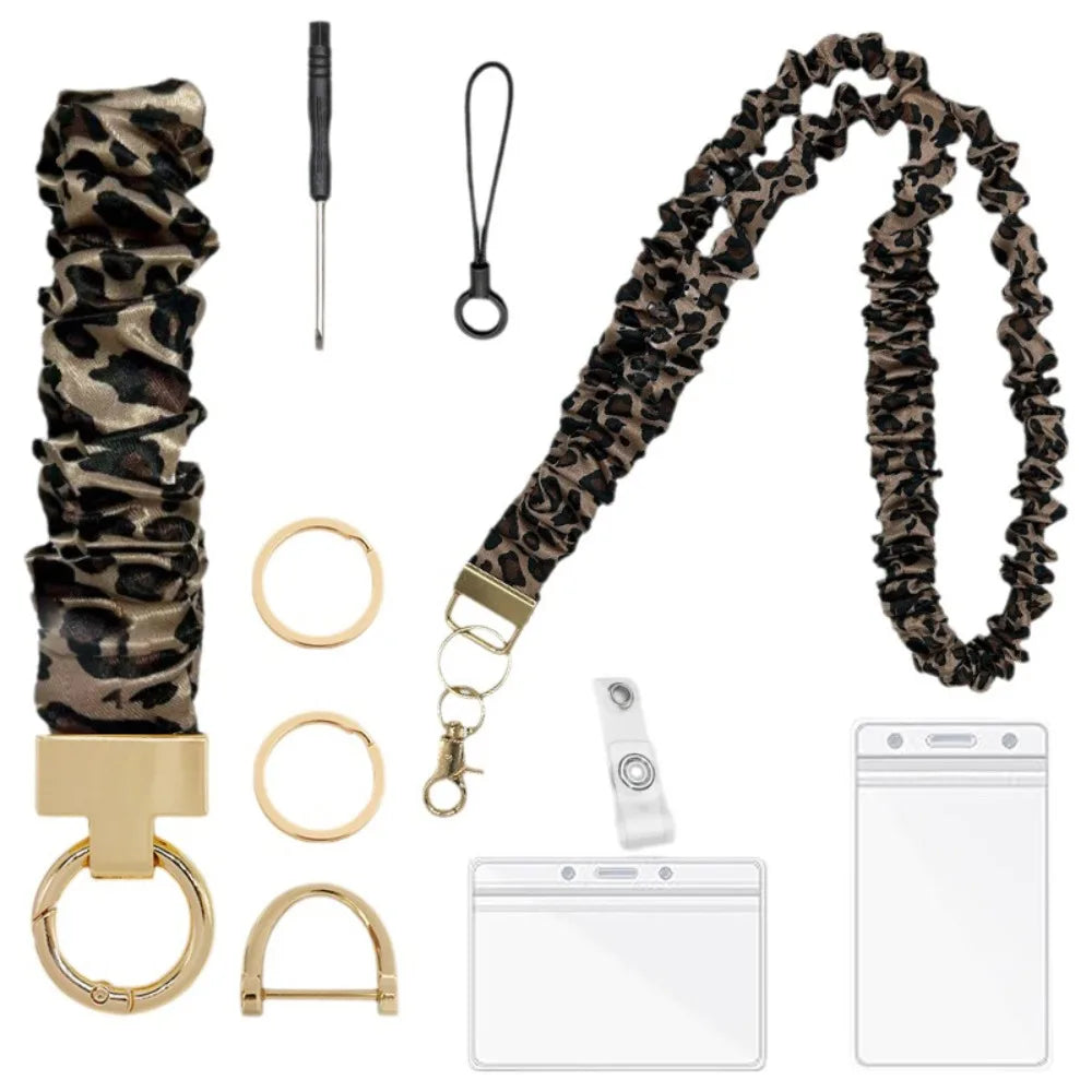 A stylish stretchy breakaway ID badge lanyard featuring a leopard print strap, gold hardware, and a retractable reel.