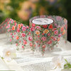 Floral vine transparent PET washi tape with pink and orange roses draped on a sheet of paper