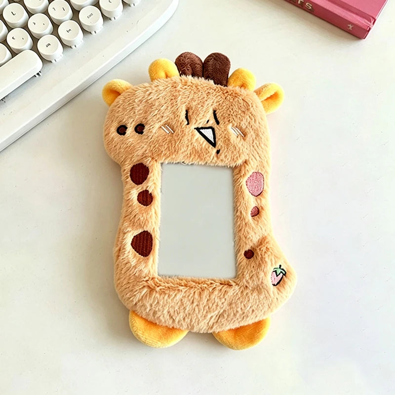 A fluffy, light brown plush holder shaped like a cat's head with ears and a mirror frame.