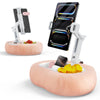 A white adjustable pillow tablet and Kindle stand with a soft pink plush fabric resting on a large, round cushion.