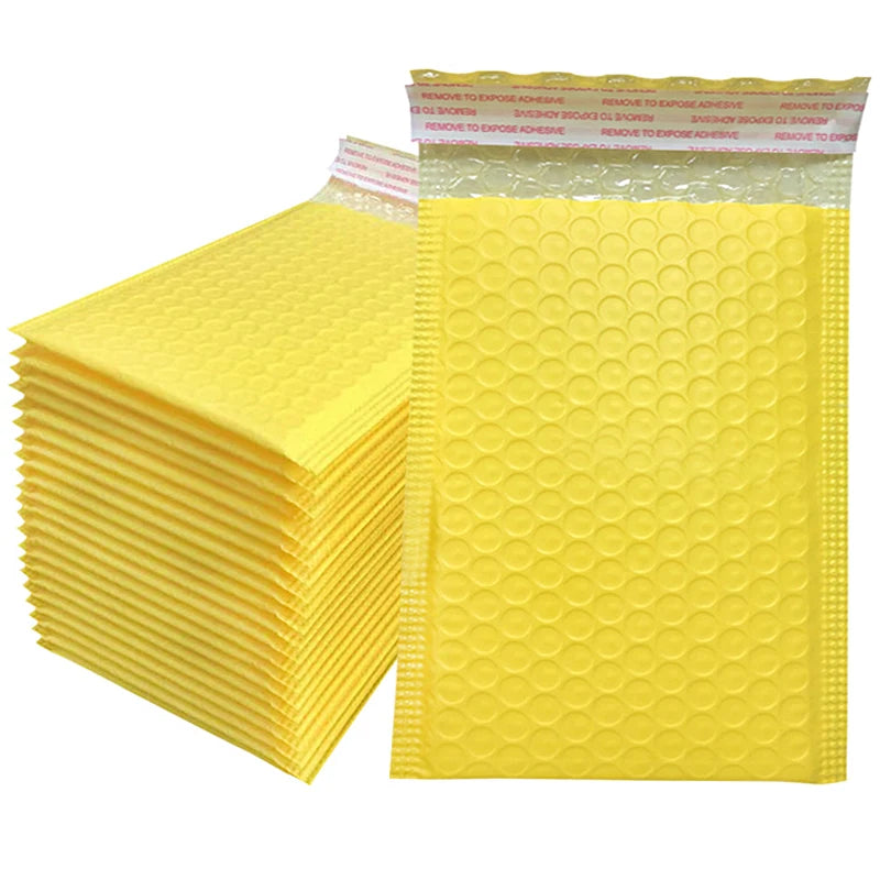 A stack of yellow padded bubble mailers with self-seal closures.