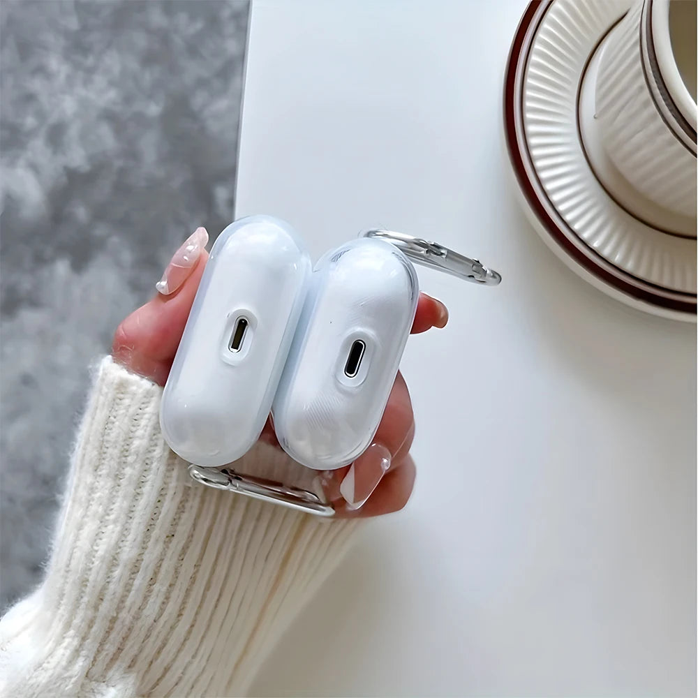 A hand holds a white TPU case for AirPods with a silver clasp, resting on a white surface.