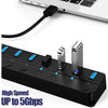 Black 7-port USB hub with individual power switches and blue LED indicators and a black cable