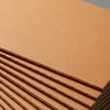 A stack of A5 Kraft cover notebooks with tight stitching shown from an angle.