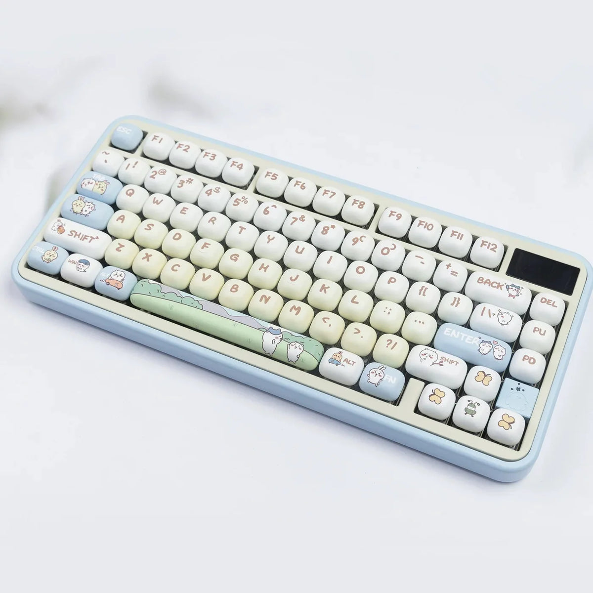 A close-up view of a light blue mechanical keyboard featuring custom dye-sublimated PBT keycaps with cute animal designs.