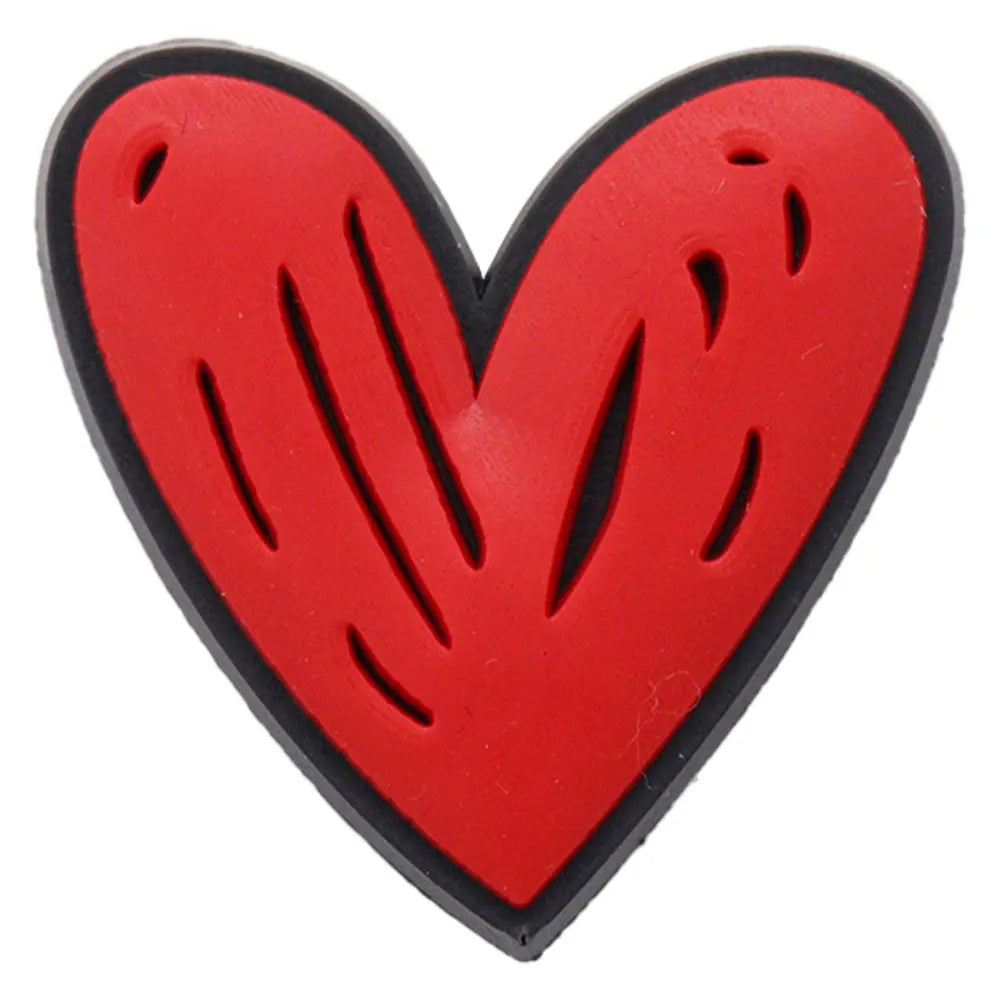 A red heart-shaped shoe charm with a black border and embossed lines.