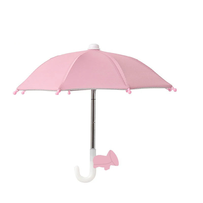 A pink umbrella stand with a suction cup base and a canopy, designed to hold a phone.