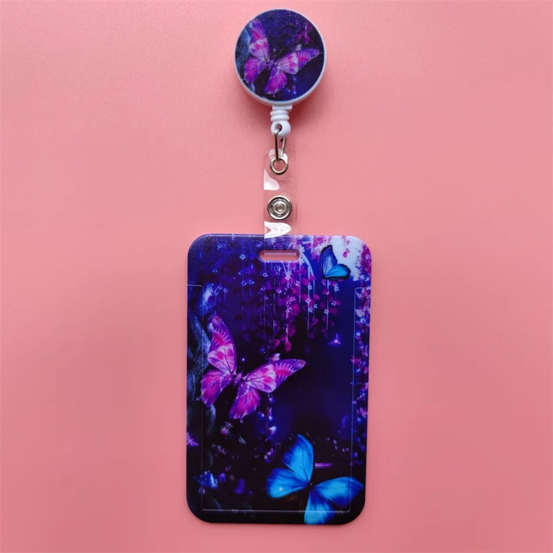A purple and blue butterfly themed card holder clip featuring iridescent colors on a pink background.
