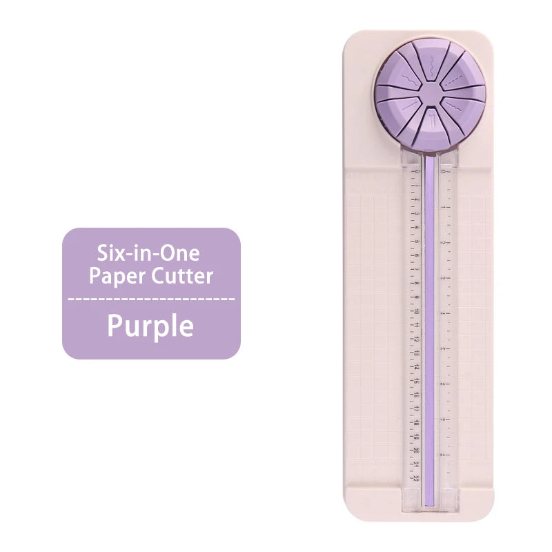 A purple six-in-one paper cutter with a clear measuring scale shown on a pink background.