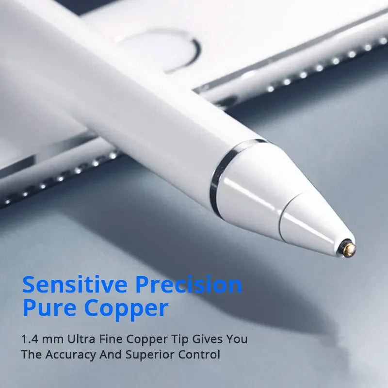 A close-up of a white pen tip with a copper coating resting on a gray surface.
