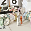 A collection of five rolls of floral patterned washi tape in various colors and designs displayed on a white surface.