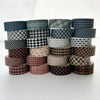 A collection of six rolls of plaid and polka dot washi tape in various shades and patterns for crafting.