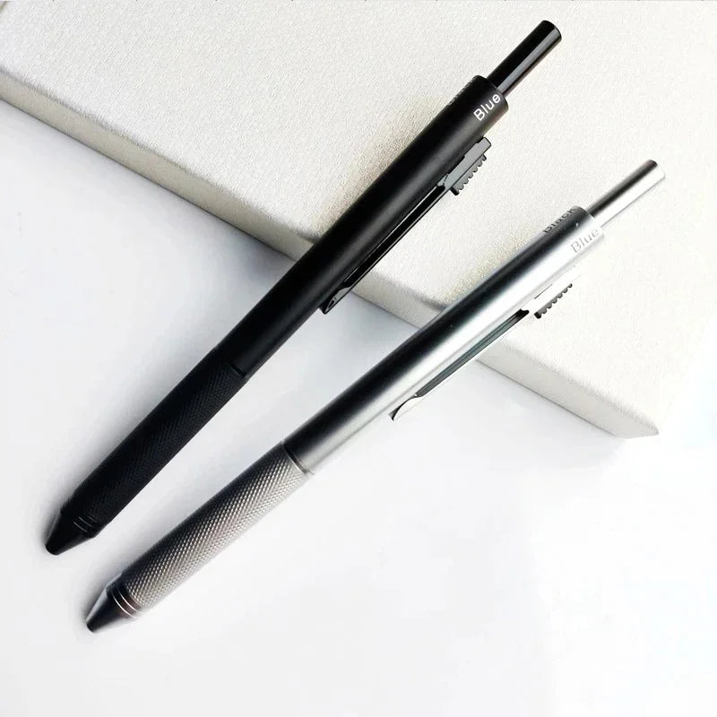 A black and silver 4-in-1 gravity sensor ballpoint pen with a mechanical pencil resting on a white surface.