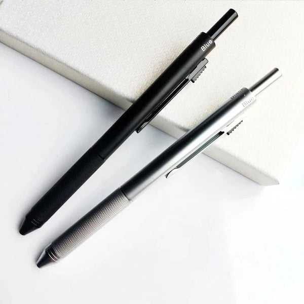 A black and silver 4-in-1 gravity sensor ballpoint pen with a mechanical pencil resting on a white surface.