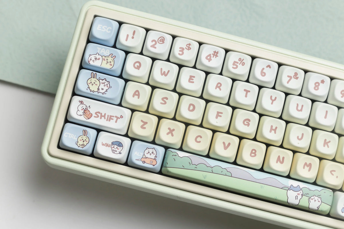 A close-up view of light-colored mechanical keyboard keycaps featuring cute animal designs like rabbits and cats.