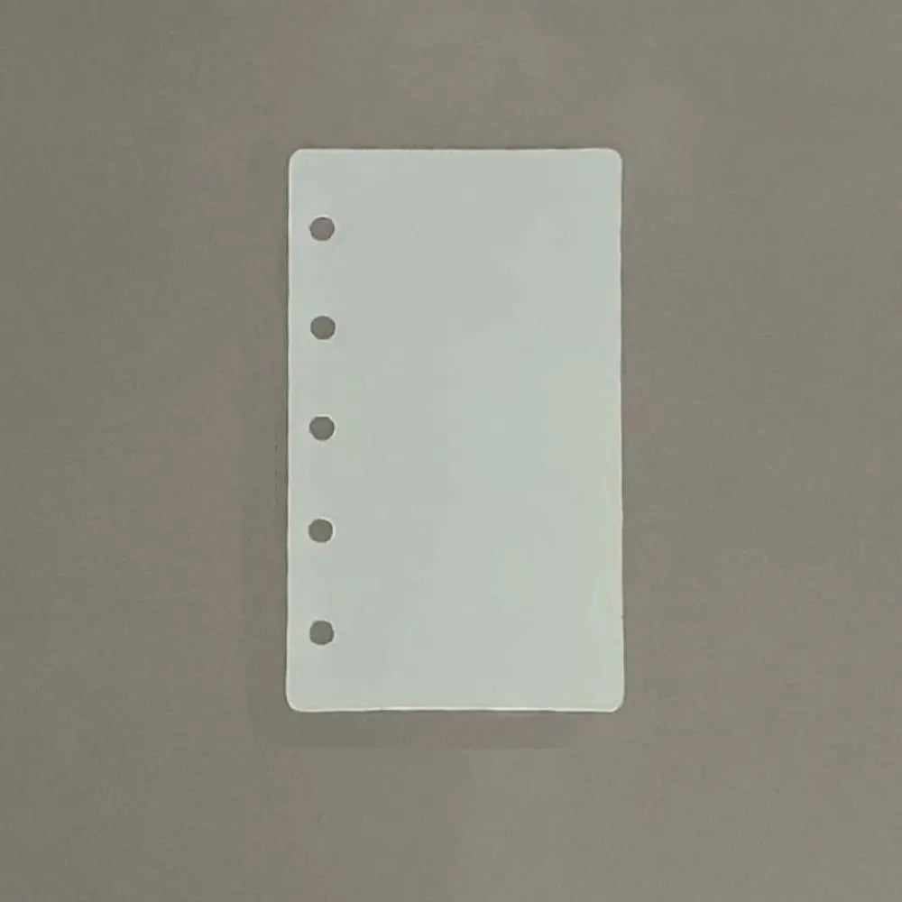 A white divider page with punched holes is shown against a neutral gray background.