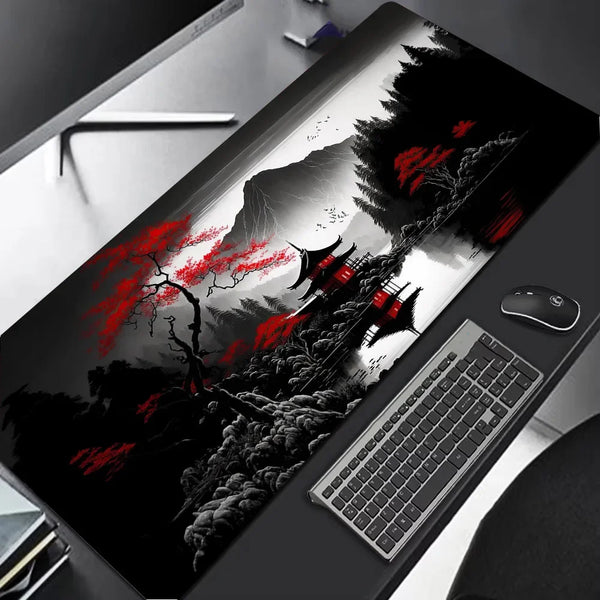 A close-up view of a large extended gaming mouse pad featuring a dramatic black and red landscape design.
