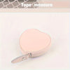 A pink PU leather measuring tape is shown with a heart-shaped component on a white background.