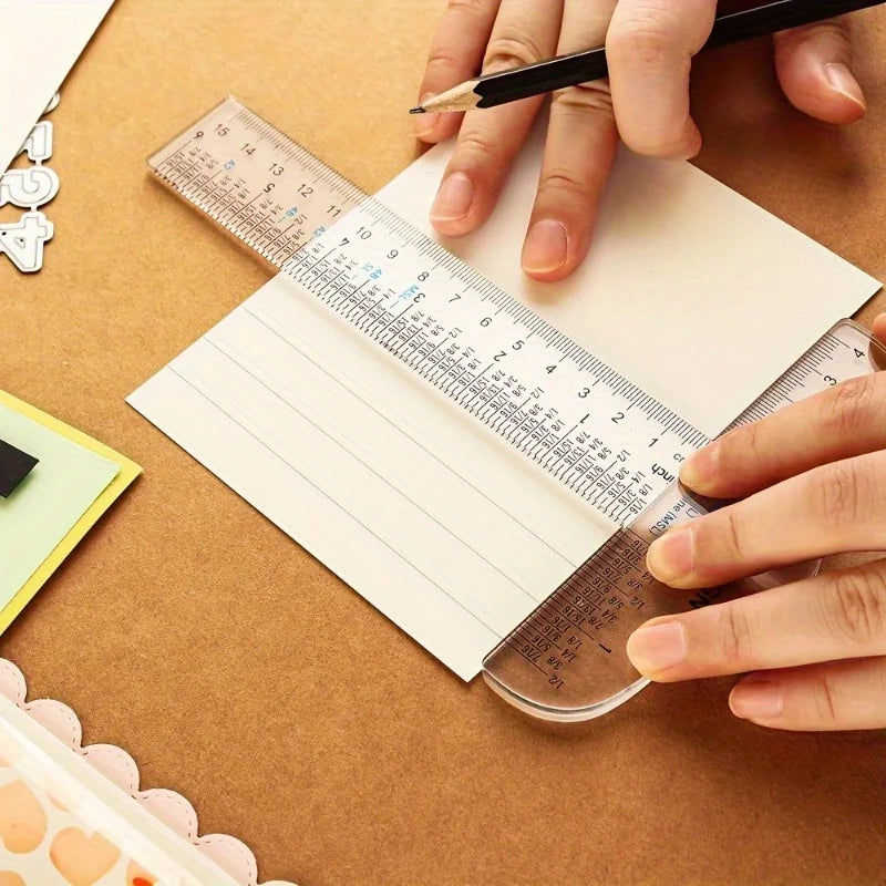 Hands measure a piece of paper using an acrylic T-square ruler for crafting and measuring.