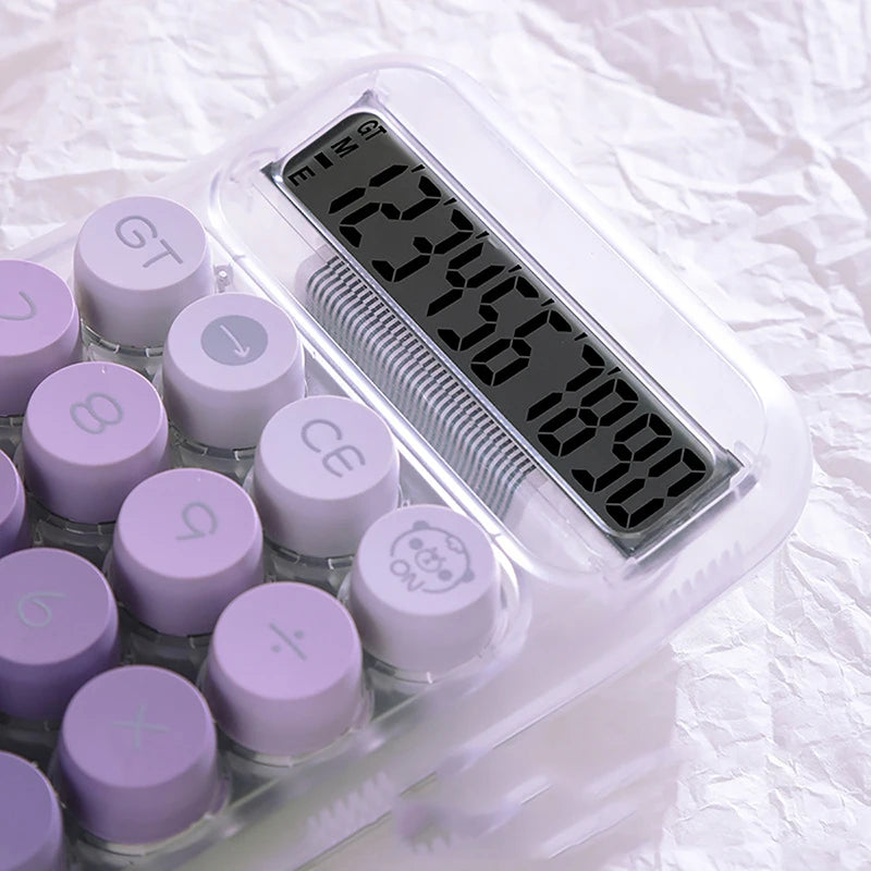 A clear plastic device with a digital display showing the number 1355.00, surrounded by purple buttons.