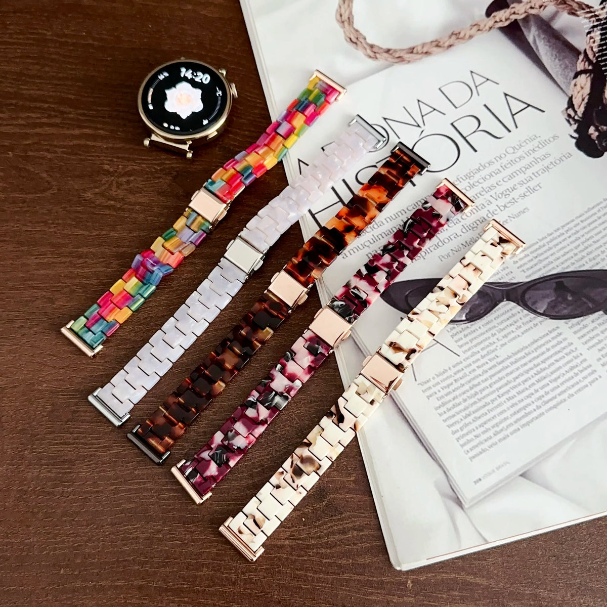 A close-up of a resin beaded watch band with a three-bead design displayed next to a book.