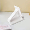A white adjustable desktop phone stand designed to hold smartphones and tablets.