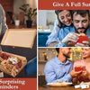 A couple is smiling while writing on a red note card, suggesting daily surprising reminders.