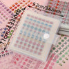 A clear plastic storage book filled with 2400 mini stickers featuring cute patterns for journaling and scrapbooking.