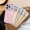 A pink and cream candy polka dot shockproof phone case for an iPhone shown in a close-up angle.