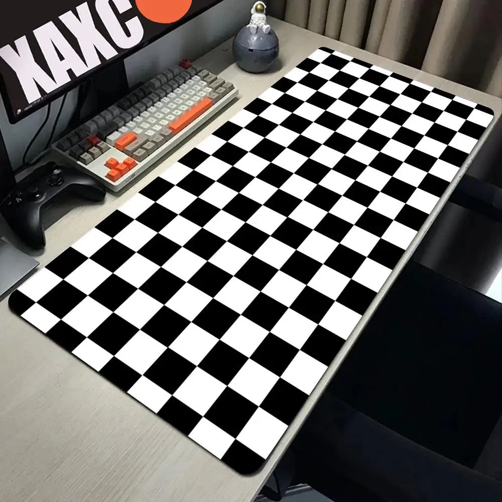A black and white checkered desk mat is placed on a wooden desk next to a keyboard and mouse.