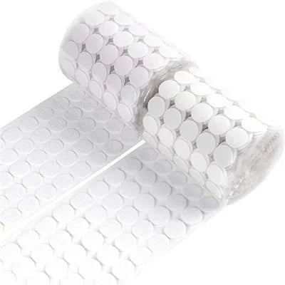 Roll of white self-adhesive hook and loop fasteners with a cylindrical shape