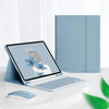 A silver magnetic keyboard case for an iPad Pro is shown next to a laptop and a mouse on a white desk.